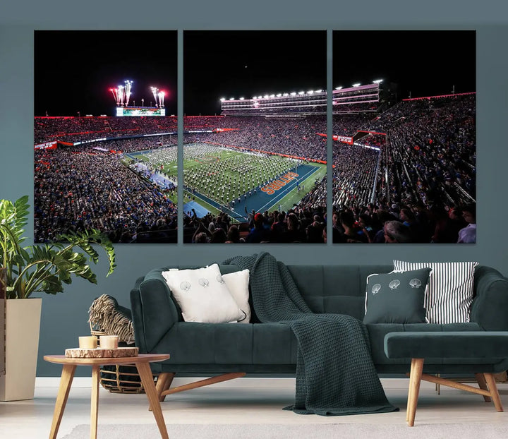 The Ben Hill Griffin Stadium Night Game Triple Canvas Wall Art - Florida Gators Football Match beautifully embodies the essence of a night game at the stadium, featuring fans, fireworks, and a marching band. This artwork is an ideal addition to a modern living room for any Florida Gators fan.