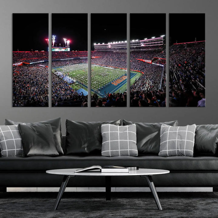 The Ben Hill Griffin Stadium Night Game Triple Canvas Wall Art - Florida Gators Football Match beautifully embodies the essence of a night game at the stadium, featuring fans, fireworks, and a marching band. This artwork is an ideal addition to a modern living room for any Florida Gators fan.