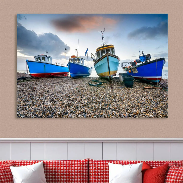 The "Big Boats On The Beach Wall Art Canvas Print" is a stunning piece featuring three museum-quality panels depicting fishing boats on a pebbled shore. Ready to hang and featuring UV-protective coating, it serves as an elegant addition to your home décor.