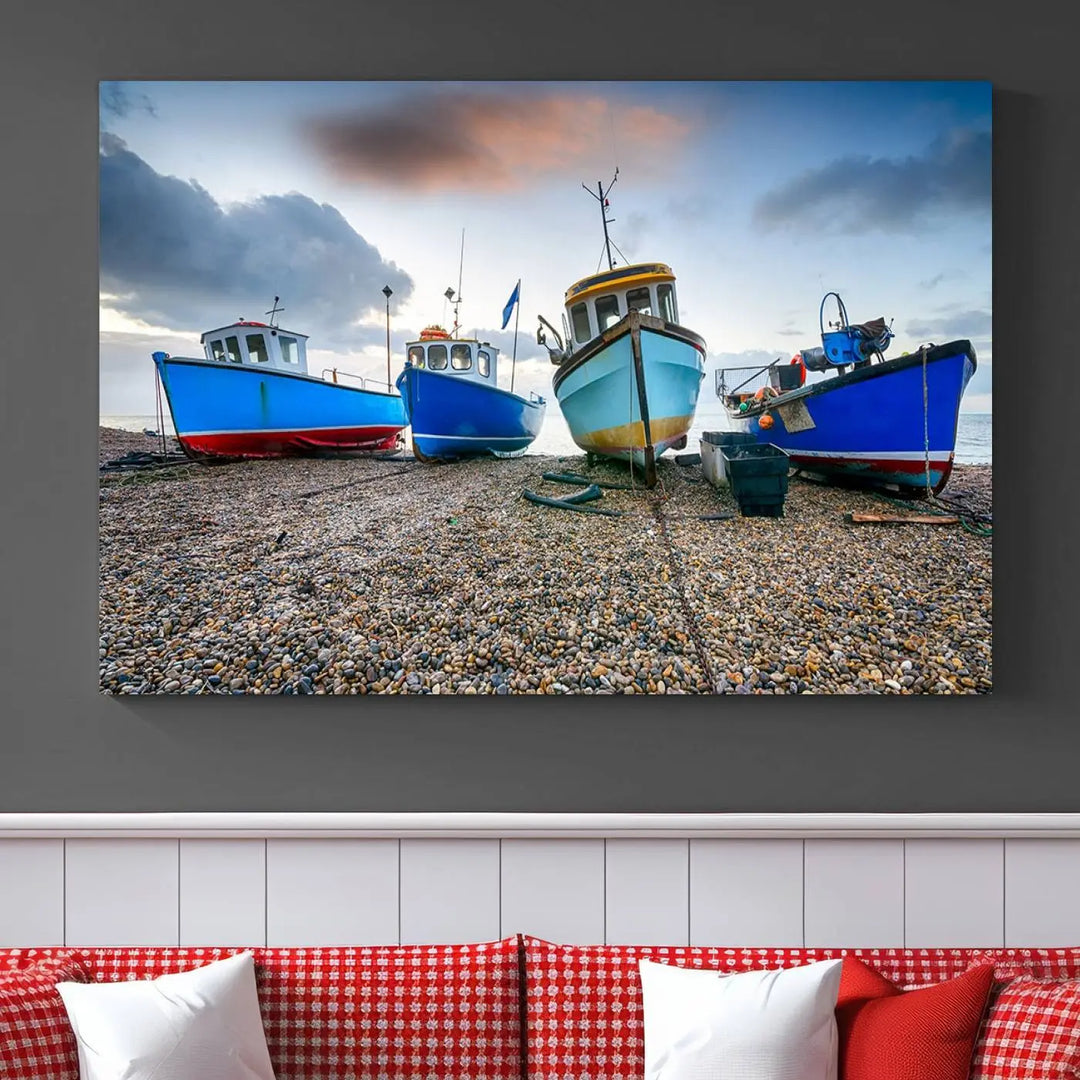 The "Big Boats On The Beach Wall Art Canvas Print" is a stunning piece featuring three museum-quality panels depicting fishing boats on a pebbled shore. Ready to hang and featuring UV-protective coating, it serves as an elegant addition to your home décor.