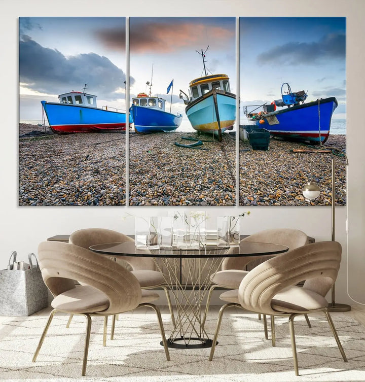 The "Big Boats On The Beach Wall Art Canvas Print" is a stunning piece featuring three museum-quality panels depicting fishing boats on a pebbled shore. Ready to hang and featuring UV-protective coating, it serves as an elegant addition to your home décor.