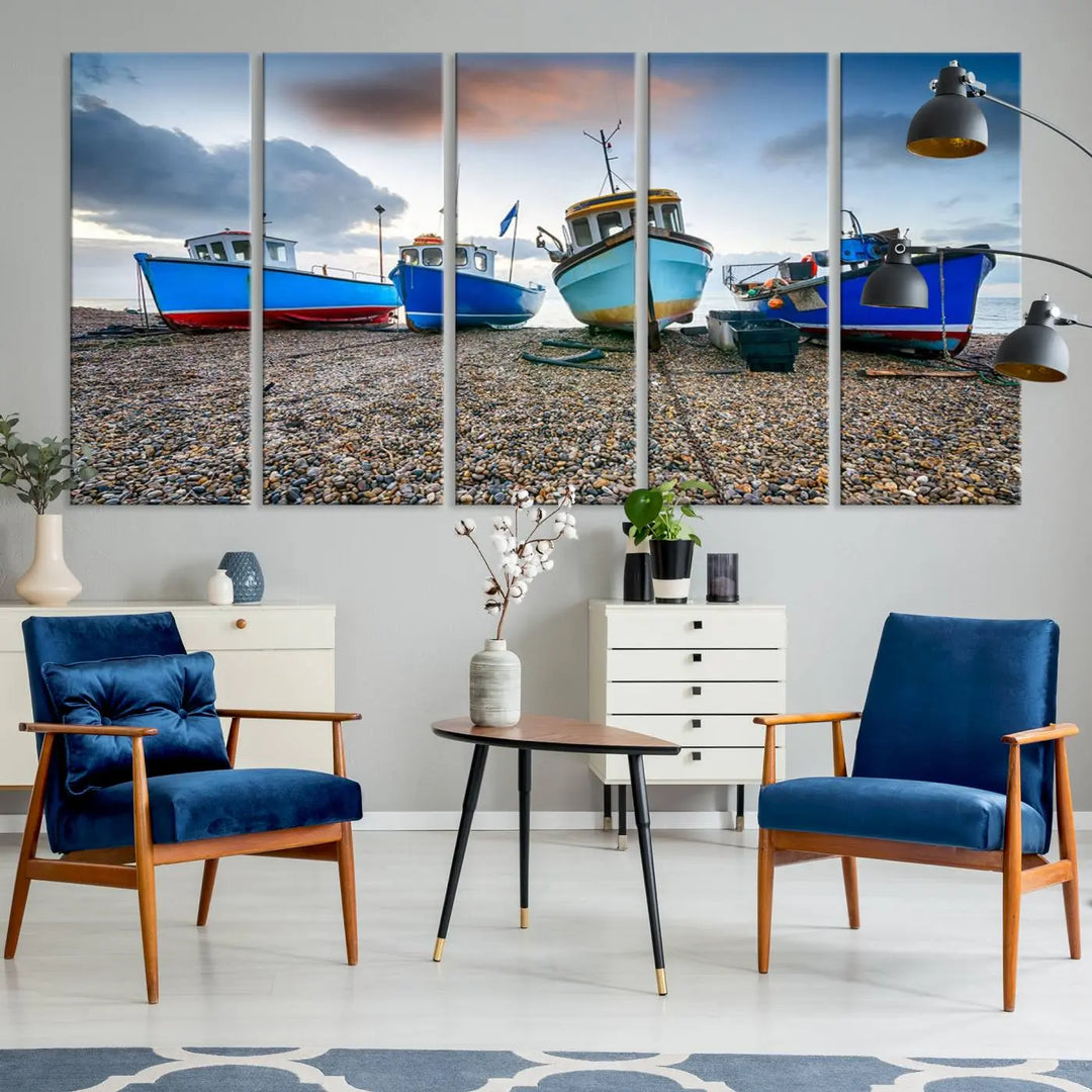 The "Big Boats On The Beach Wall Art Canvas Print" is a stunning piece featuring three museum-quality panels depicting fishing boats on a pebbled shore. Ready to hang and featuring UV-protective coating, it serves as an elegant addition to your home décor.