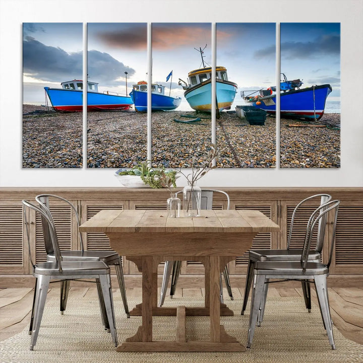 The "Big Boats On The Beach Wall Art Canvas Print" is a stunning piece featuring three museum-quality panels depicting fishing boats on a pebbled shore. Ready to hang and featuring UV-protective coating, it serves as an elegant addition to your home décor.