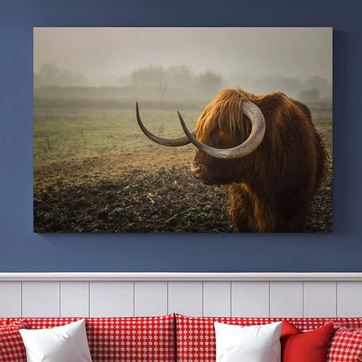 The "Big Cow Horn Wall Art Canvas Print" is a hand-assembled framed canvas depicting a Highland cow in a misty field. It is crafted with a UV-protective coating to ensure lasting vibrancy.