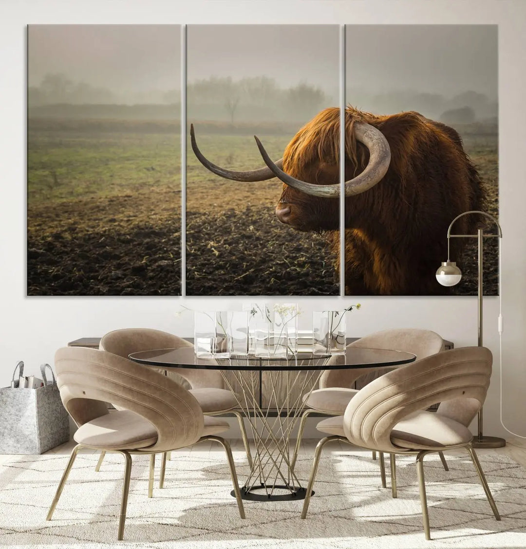 The "Big Cow Horn Wall Art Canvas Print" is a hand-assembled framed canvas depicting a Highland cow in a misty field. It is crafted with a UV-protective coating to ensure lasting vibrancy.