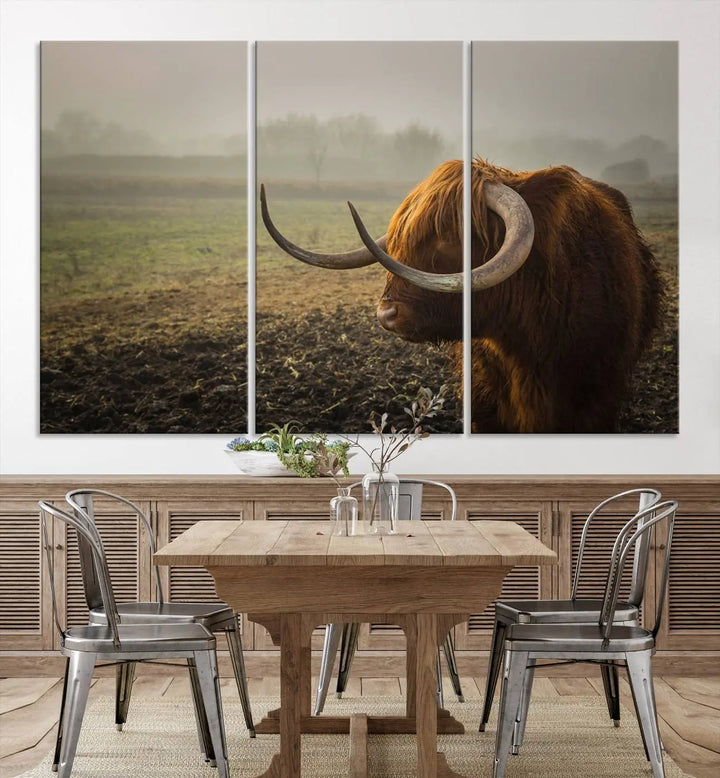 The "Big Cow Horn Wall Art Canvas Print" is a hand-assembled framed canvas depicting a Highland cow in a misty field. It is crafted with a UV-protective coating to ensure lasting vibrancy.