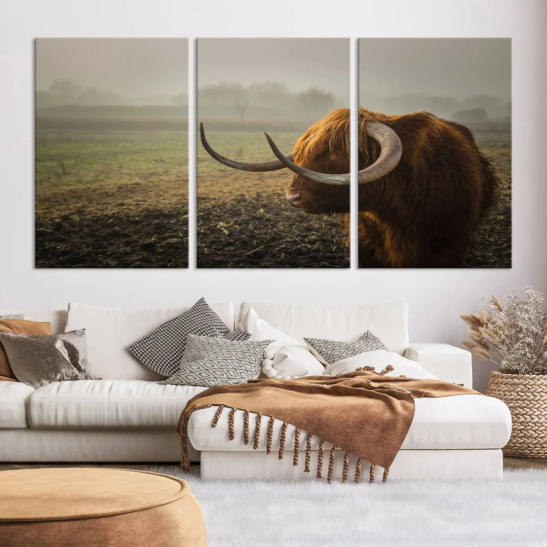 The "Big Cow Horn Wall Art Canvas Print" is a hand-assembled framed canvas depicting a Highland cow in a misty field. It is crafted with a UV-protective coating to ensure lasting vibrancy.