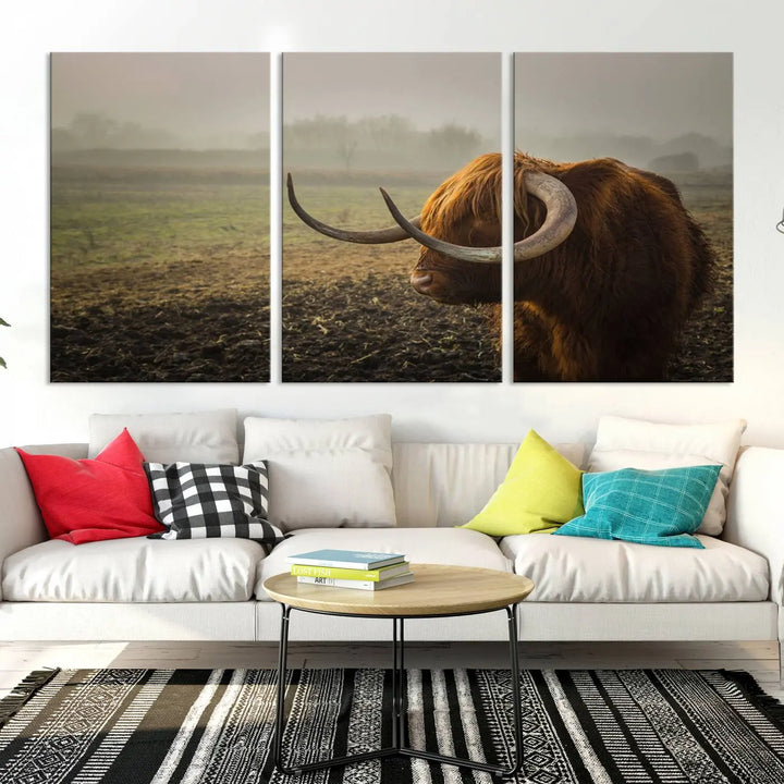 The "Big Cow Horn Wall Art Canvas Print" is a hand-assembled framed canvas depicting a Highland cow in a misty field. It is crafted with a UV-protective coating to ensure lasting vibrancy.