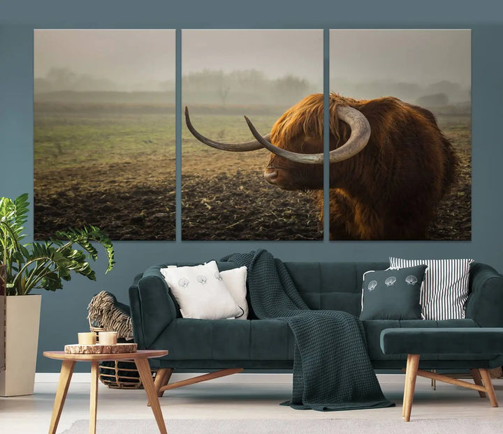 The "Big Cow Horn Wall Art Canvas Print" is a hand-assembled framed canvas depicting a Highland cow in a misty field. It is crafted with a UV-protective coating to ensure lasting vibrancy.