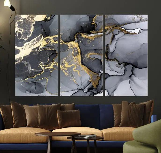 The Black Marble Fluid Effect Wall Art Abstract Canvas Wall Art Print features a triptych of black, gray, and gold abstract designs on museum-quality canvas. This elegant piece is ready to hang and includes a UV-protective coating to ensure its enduring allure.