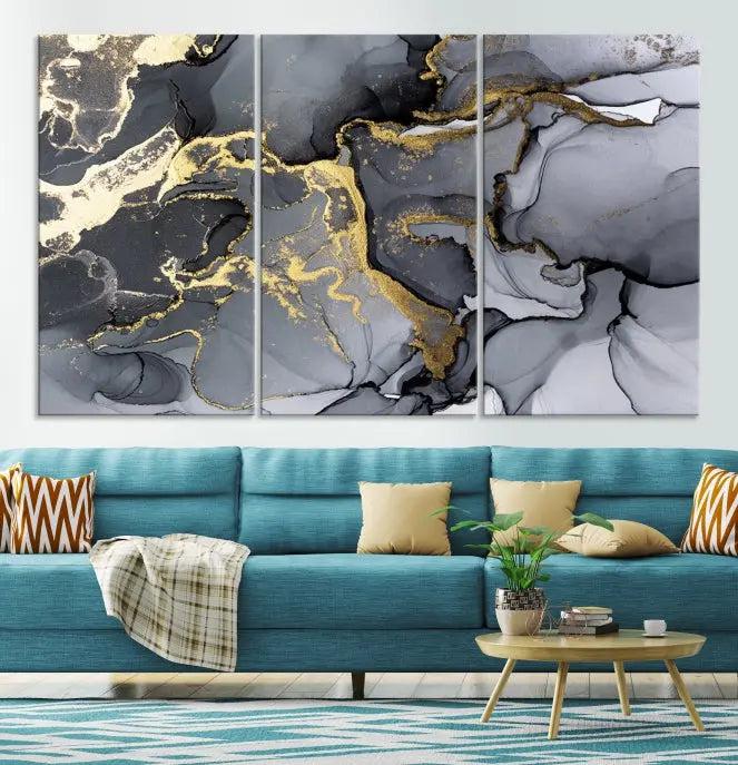 The Black Marble Fluid Effect Wall Art Abstract Canvas Wall Art Print features a triptych of black, gray, and gold abstract designs on museum-quality canvas. This elegant piece is ready to hang and includes a UV-protective coating to ensure its enduring allure.