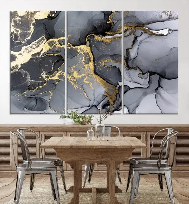 The Black Marble Fluid Effect Wall Art Abstract Canvas Wall Art Print features a triptych of black, gray, and gold abstract designs on museum-quality canvas. This elegant piece is ready to hang and includes a UV-protective coating to ensure its enduring allure.