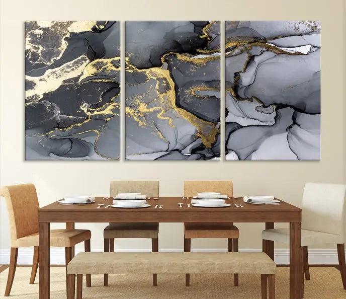 The Black Marble Fluid Effect Wall Art Abstract Canvas Wall Art Print features a triptych of black, gray, and gold abstract designs on museum-quality canvas. This elegant piece is ready to hang and includes a UV-protective coating to ensure its enduring allure.