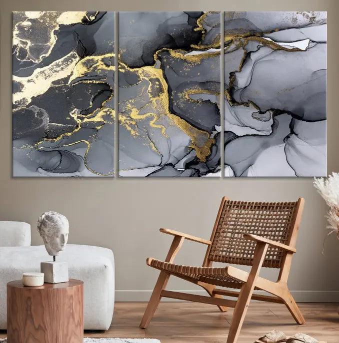 The Black Marble Fluid Effect Wall Art Abstract Canvas Wall Art Print features a triptych of black, gray, and gold abstract designs on museum-quality canvas. This elegant piece is ready to hang and includes a UV-protective coating to ensure its enduring allure.