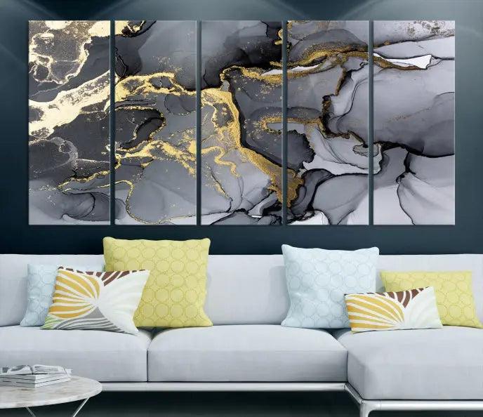 The Black Marble Fluid Effect Wall Art Abstract Canvas Wall Art Print features a triptych of black, gray, and gold abstract designs on museum-quality canvas. This elegant piece is ready to hang and includes a UV-protective coating to ensure its enduring allure.