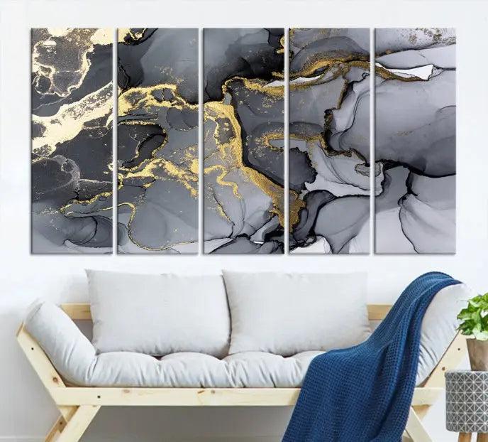 The Black Marble Fluid Effect Wall Art Abstract Canvas Wall Art Print features a triptych of black, gray, and gold abstract designs on museum-quality canvas. This elegant piece is ready to hang and includes a UV-protective coating to ensure its enduring allure.