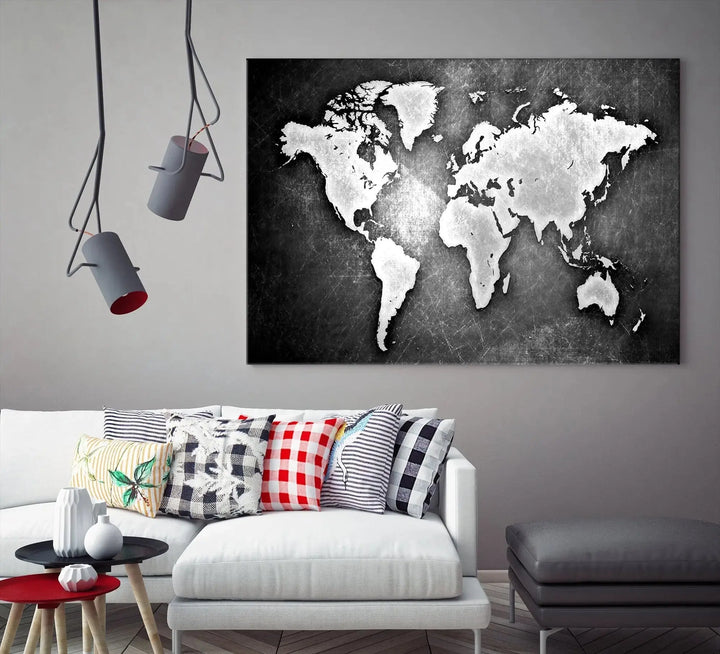 The Black Metallic Wall Art World Map Canvas Print, crafted on museum-quality canvas, adorns a textured wall. The gallery-wrapped artwork features a UV-protective coating that ensures the stunning colors will endure over time.