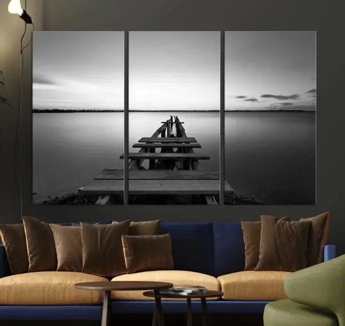 Titled "Black & White Old Wooden Pier Wall Art Canvas Print," this stunning monochrome triptych of a pier at sunset is printed on museum-grade canvases. It offers an effortlessly chic ambiance to your space with its ready-to-hang design.