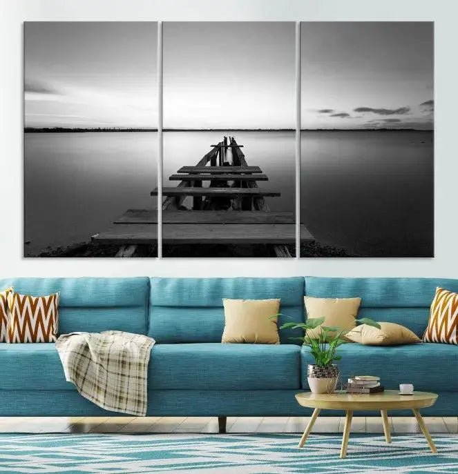 Titled "Black & White Old Wooden Pier Wall Art Canvas Print," this stunning monochrome triptych of a pier at sunset is printed on museum-grade canvases. It offers an effortlessly chic ambiance to your space with its ready-to-hang design.