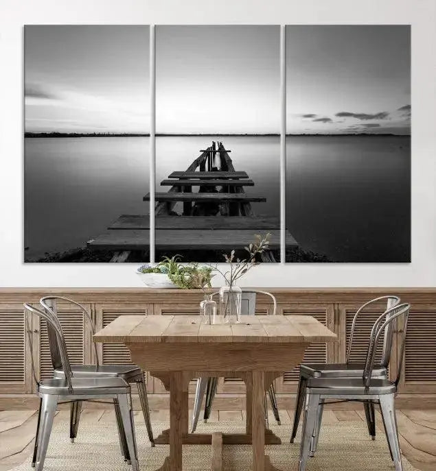 Titled "Black & White Old Wooden Pier Wall Art Canvas Print," this stunning monochrome triptych of a pier at sunset is printed on museum-grade canvases. It offers an effortlessly chic ambiance to your space with its ready-to-hang design.