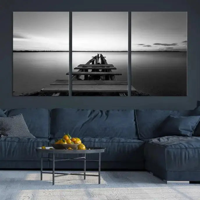 Titled "Black & White Old Wooden Pier Wall Art Canvas Print," this stunning monochrome triptych of a pier at sunset is printed on museum-grade canvases. It offers an effortlessly chic ambiance to your space with its ready-to-hang design.