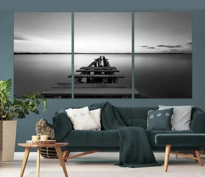 Titled "Black & White Old Wooden Pier Wall Art Canvas Print," this stunning monochrome triptych of a pier at sunset is printed on museum-grade canvases. It offers an effortlessly chic ambiance to your space with its ready-to-hang design.