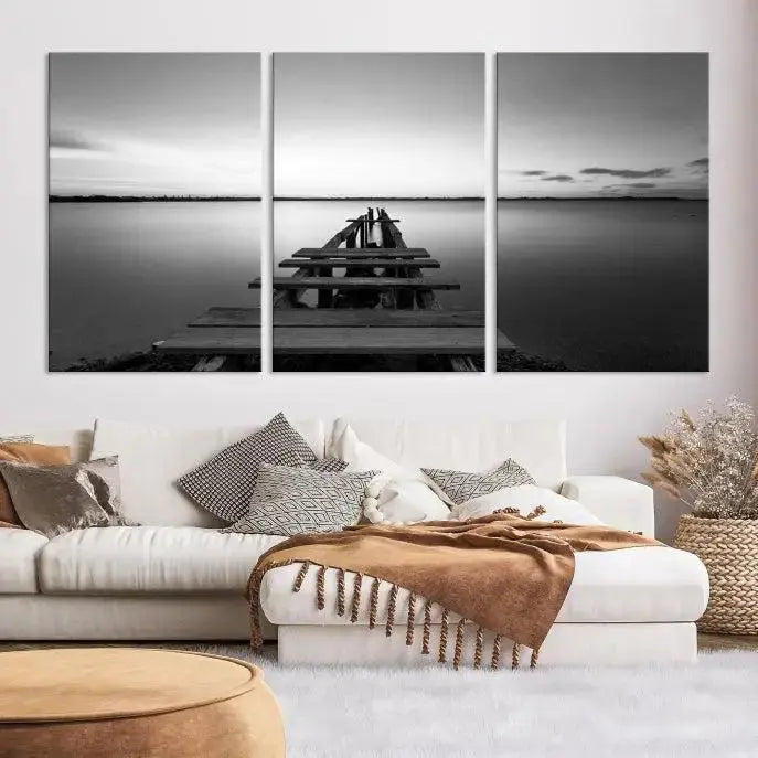 Titled "Black & White Old Wooden Pier Wall Art Canvas Print," this stunning monochrome triptych of a pier at sunset is printed on museum-grade canvases. It offers an effortlessly chic ambiance to your space with its ready-to-hang design.