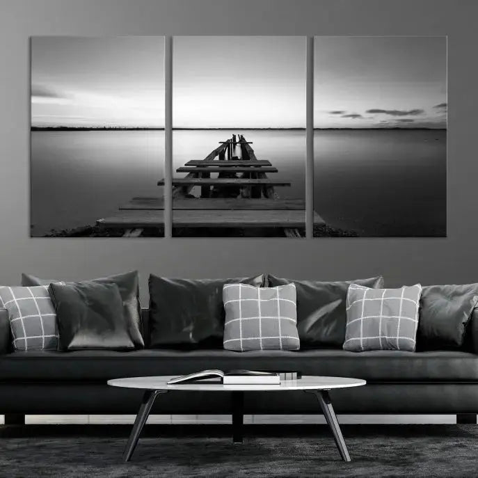 Titled "Black & White Old Wooden Pier Wall Art Canvas Print," this stunning monochrome triptych of a pier at sunset is printed on museum-grade canvases. It offers an effortlessly chic ambiance to your space with its ready-to-hang design.