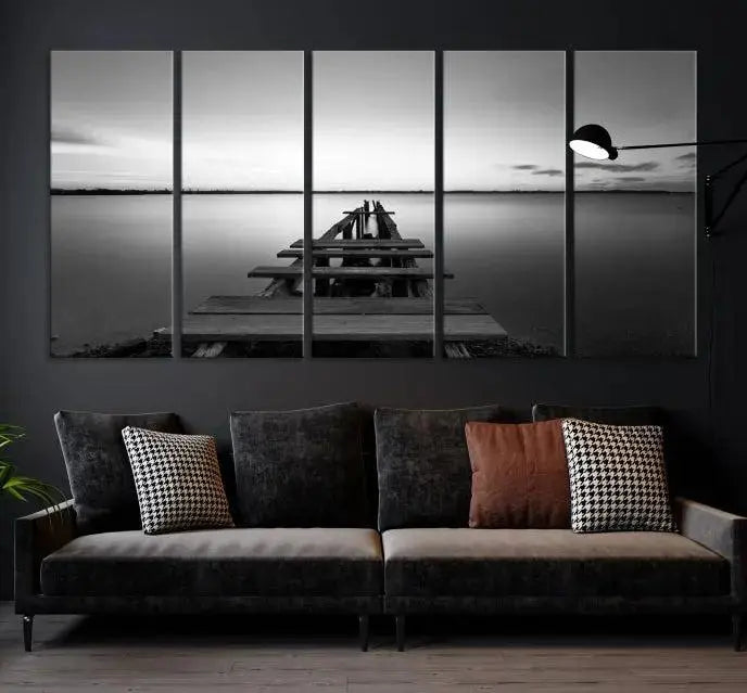 Titled "Black & White Old Wooden Pier Wall Art Canvas Print," this stunning monochrome triptych of a pier at sunset is printed on museum-grade canvases. It offers an effortlessly chic ambiance to your space with its ready-to-hang design.