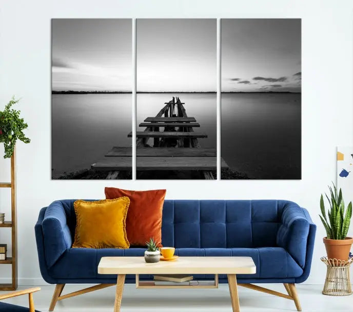 Titled "Black & White Old Wooden Pier Wall Art Canvas Print," this stunning monochrome triptych of a pier at sunset is printed on museum-grade canvases. It offers an effortlessly chic ambiance to your space with its ready-to-hang design.