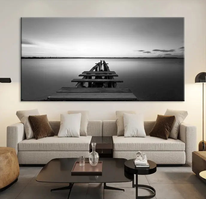 Titled "Black & White Old Wooden Pier Wall Art Canvas Print," this stunning monochrome triptych of a pier at sunset is printed on museum-grade canvases. It offers an effortlessly chic ambiance to your space with its ready-to-hang design.