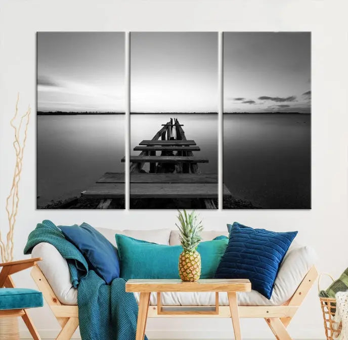 Titled "Black & White Old Wooden Pier Wall Art Canvas Print," this stunning monochrome triptych of a pier at sunset is printed on museum-grade canvases. It offers an effortlessly chic ambiance to your space with its ready-to-hang design.