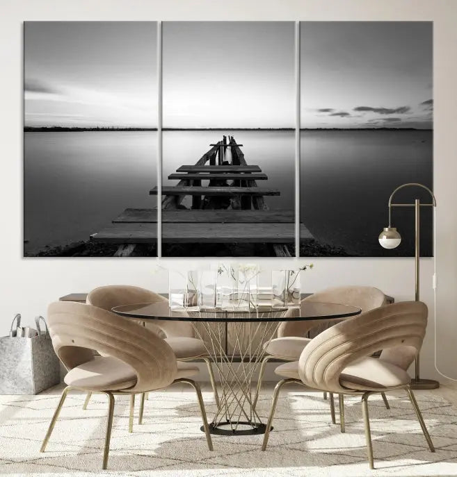 Titled "Black & White Old Wooden Pier Wall Art Canvas Print," this stunning monochrome triptych of a pier at sunset is printed on museum-grade canvases. It offers an effortlessly chic ambiance to your space with its ready-to-hang design.