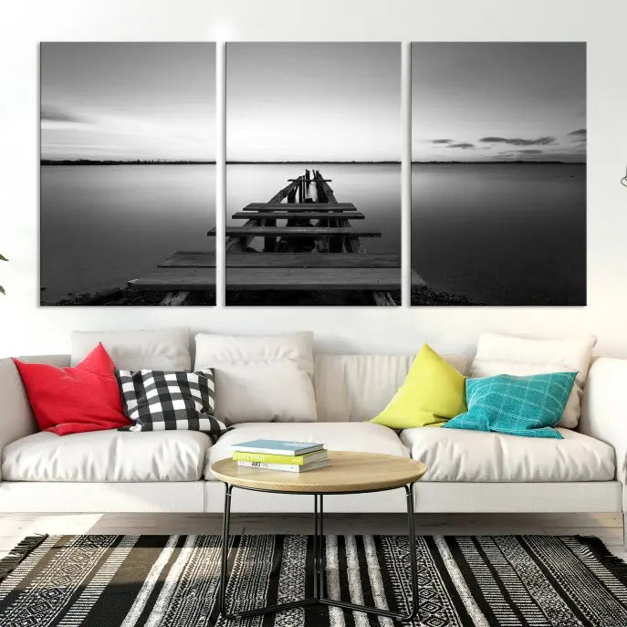 Titled "Black & White Old Wooden Pier Wall Art Canvas Print," this stunning monochrome triptych of a pier at sunset is printed on museum-grade canvases. It offers an effortlessly chic ambiance to your space with its ready-to-hang design.