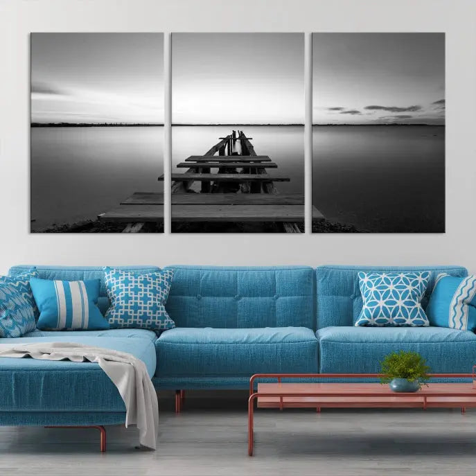 Titled "Black & White Old Wooden Pier Wall Art Canvas Print," this stunning monochrome triptych of a pier at sunset is printed on museum-grade canvases. It offers an effortlessly chic ambiance to your space with its ready-to-hang design.