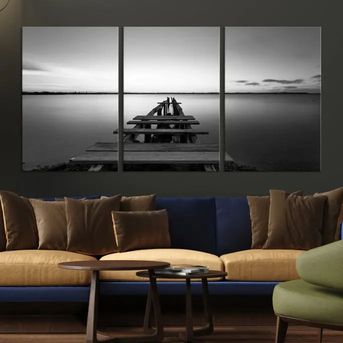 Titled "Black & White Old Wooden Pier Wall Art Canvas Print," this stunning monochrome triptych of a pier at sunset is printed on museum-grade canvases. It offers an effortlessly chic ambiance to your space with its ready-to-hang design.