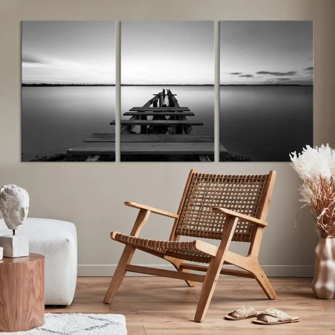 Titled "Black & White Old Wooden Pier Wall Art Canvas Print," this stunning monochrome triptych of a pier at sunset is printed on museum-grade canvases. It offers an effortlessly chic ambiance to your space with its ready-to-hang design.