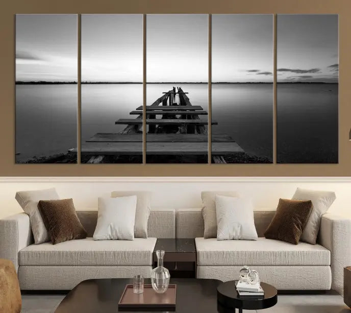 Titled "Black & White Old Wooden Pier Wall Art Canvas Print," this stunning monochrome triptych of a pier at sunset is printed on museum-grade canvases. It offers an effortlessly chic ambiance to your space with its ready-to-hang design.