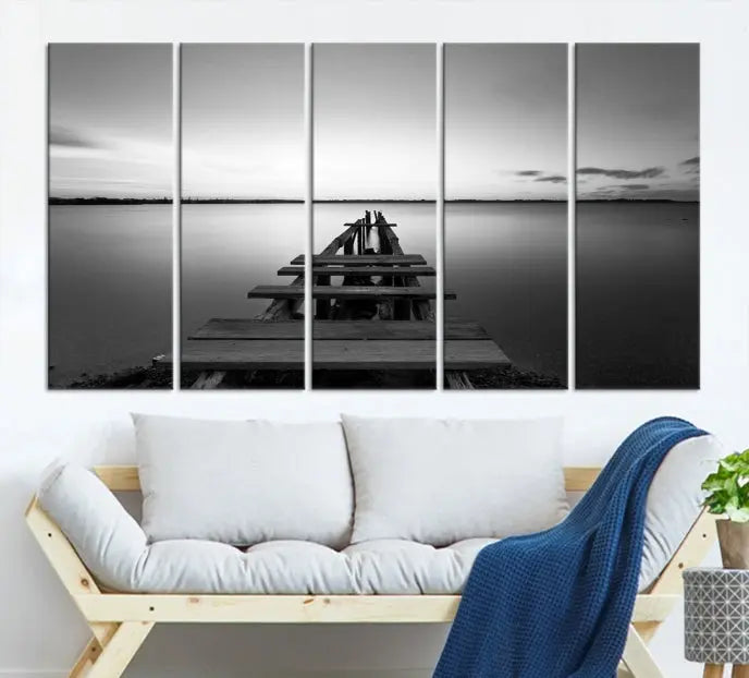 Titled "Black & White Old Wooden Pier Wall Art Canvas Print," this stunning monochrome triptych of a pier at sunset is printed on museum-grade canvases. It offers an effortlessly chic ambiance to your space with its ready-to-hang design.