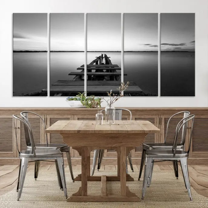 Titled "Black & White Old Wooden Pier Wall Art Canvas Print," this stunning monochrome triptych of a pier at sunset is printed on museum-grade canvases. It offers an effortlessly chic ambiance to your space with its ready-to-hang design.