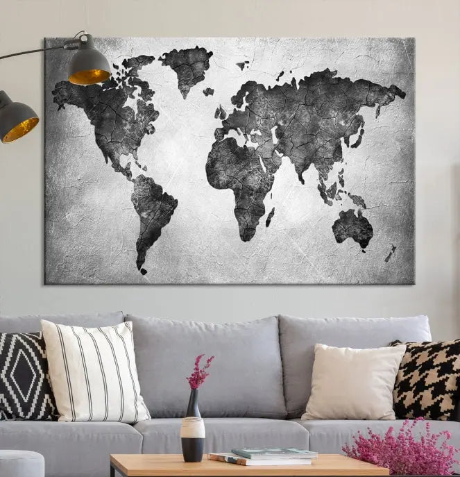 A Black and Gray World Map Canvas Wall Art Print, created on museum-quality canvas with UV-protective coating, hangs prominently.