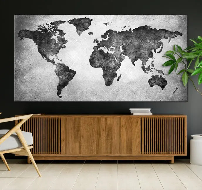 A Black and Gray World Map Canvas Wall Art Print, created on museum-quality canvas with UV-protective coating, hangs prominently.