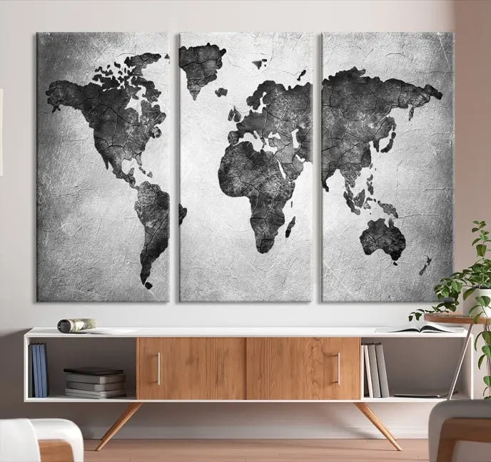 A Black and Gray World Map Canvas Wall Art Print, created on museum-quality canvas with UV-protective coating, hangs prominently.