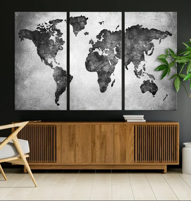 A Black and Gray World Map Canvas Wall Art Print, created on museum-quality canvas with UV-protective coating, hangs prominently.