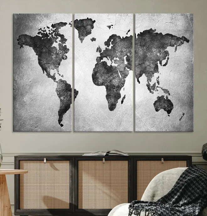 A Black and Gray World Map Canvas Wall Art Print, created on museum-quality canvas with UV-protective coating, hangs prominently.