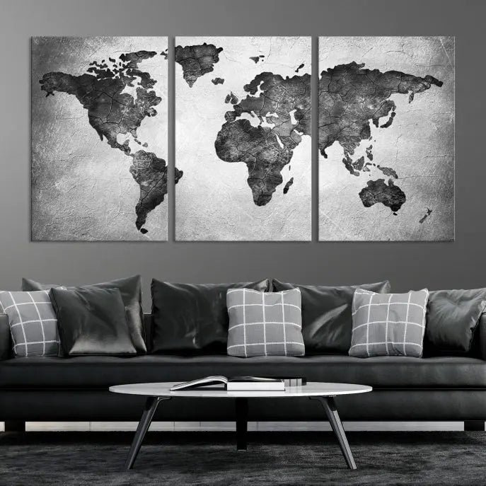 A Black and Gray World Map Canvas Wall Art Print, created on museum-quality canvas with UV-protective coating, hangs prominently.