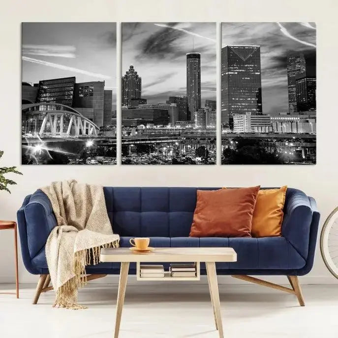 A modern living room featuring the Black and White Atlanta Wall Art Canvas Print as a triptych, displayed on museum-quality canvas and ready to hang.