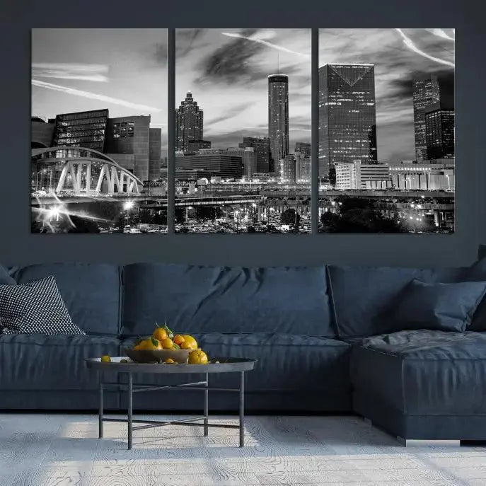 A modern living room featuring the Black and White Atlanta Wall Art Canvas Print as a triptych, displayed on museum-quality canvas and ready to hang.