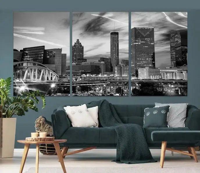 A modern living room featuring the Black and White Atlanta Wall Art Canvas Print as a triptych, displayed on museum-quality canvas and ready to hang.