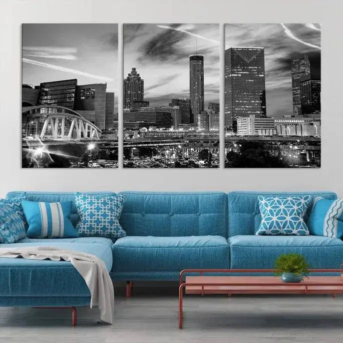 A modern living room featuring the Black and White Atlanta Wall Art Canvas Print as a triptych, displayed on museum-quality canvas and ready to hang.